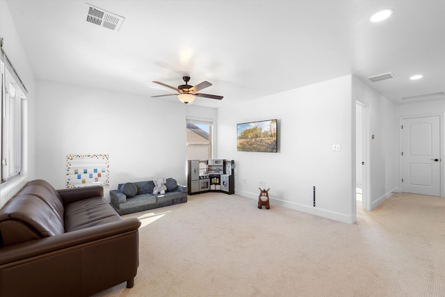 6052 Nauman Dr SE, Albuquerque, NM 87106 - living room with light carpet, a ceiling fan, visible vents, and baseboards