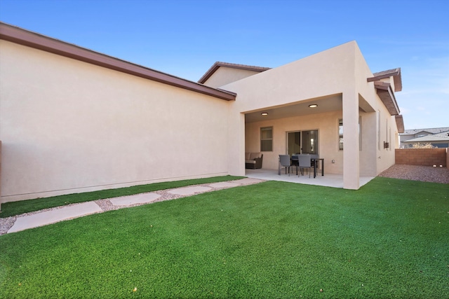 6052 Nauman Dr SE, Albuquerque, NM 87106 - rear view of house with a patio area, a yard, fence, and stucco siding