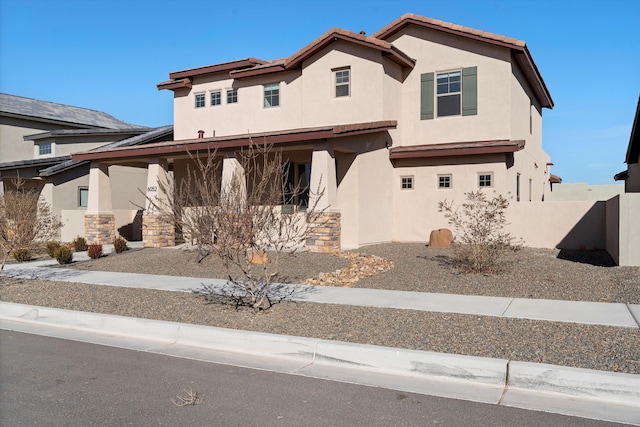 6052 Nauman Dr SE, Albuquerque, NM 87106 - view of front of house featuring a tile roof, fence, and stucco siding