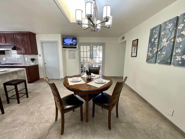 dining space with a chandelier, french doors, visible vents, and baseboards