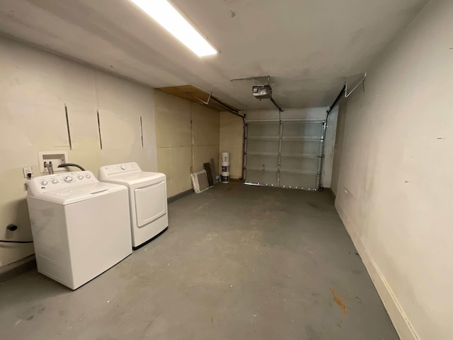 garage featuring a garage door opener and washing machine and clothes dryer