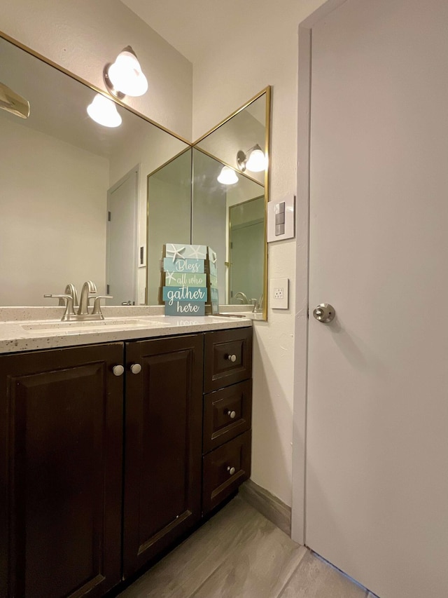 bathroom with baseboards and vanity