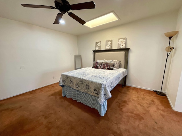 carpeted bedroom with ceiling fan and baseboards