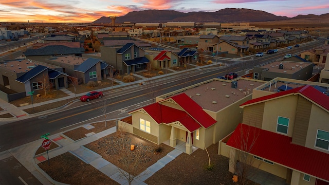 aerial view at dusk with a residential view and a mountain view