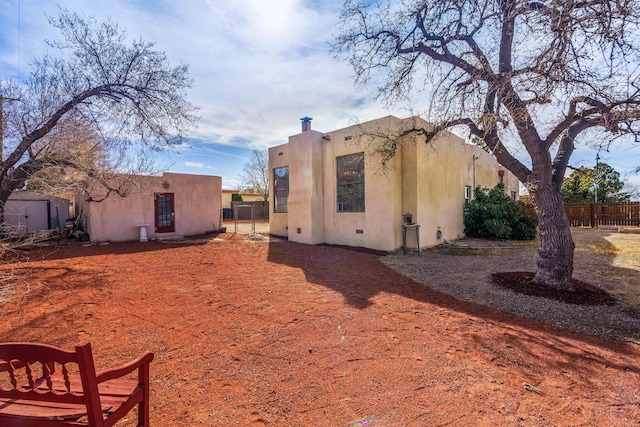 view of property exterior featuring fence and stucco siding