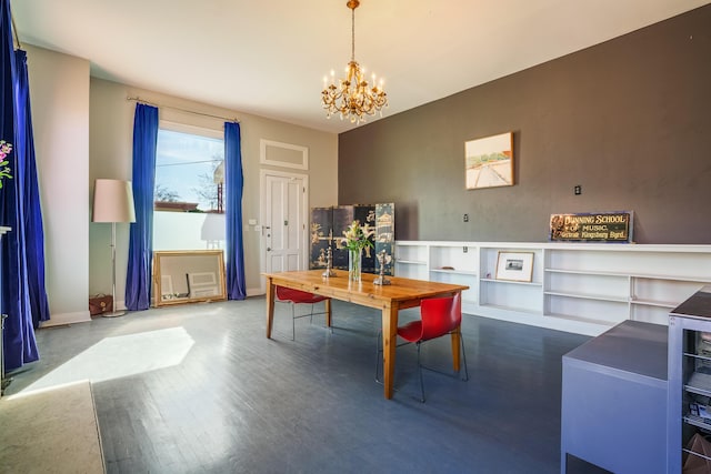 dining space with baseboards, a notable chandelier, and wood finished floors