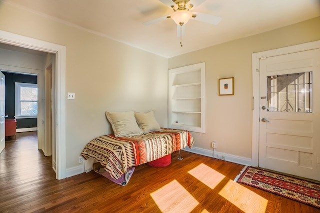 interior space featuring dark wood-style floors, ceiling fan, and baseboards