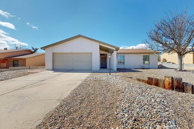 view of front of property with board and batten siding, concrete driveway, brick siding, and an attached garage