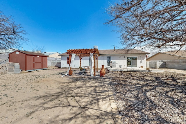 back of house with an outbuilding, stucco siding, a storage unit, fence, and a pergola