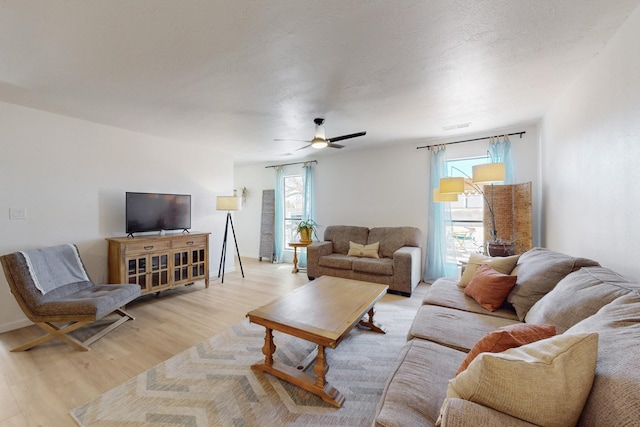 living room featuring light wood-style floors and ceiling fan