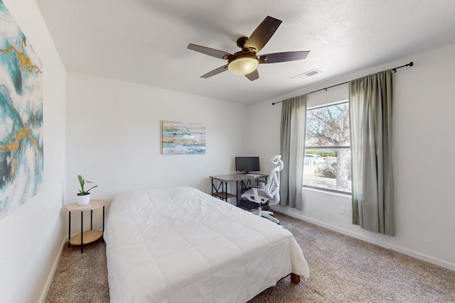 bedroom with a ceiling fan, baseboards, visible vents, and carpet flooring