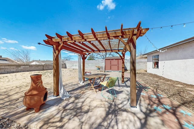 view of patio / terrace with a storage shed, a fenced backyard, a pergola, and an outdoor structure