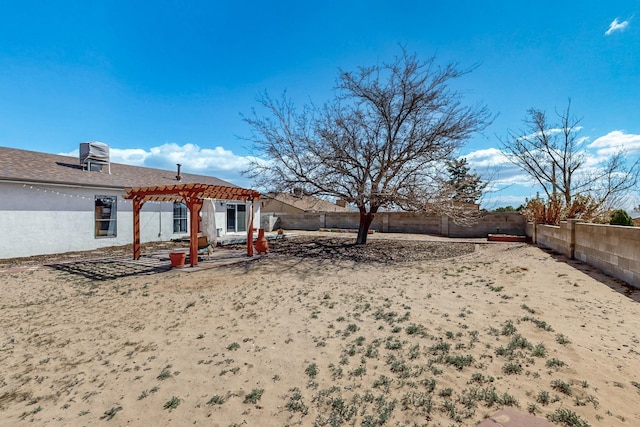 view of yard with a patio area, a fenced backyard, central AC unit, and a pergola