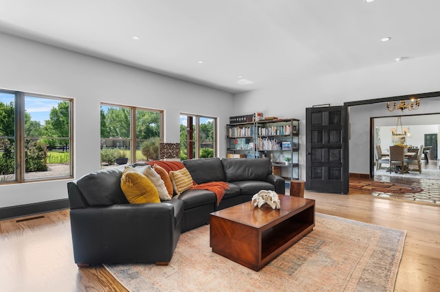 living room with a chandelier, recessed lighting, visible vents, and light wood-style flooring