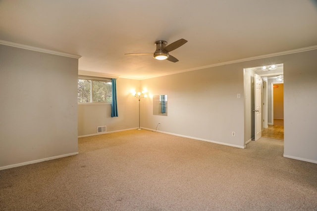 spare room featuring visible vents, light colored carpet, and ornamental molding