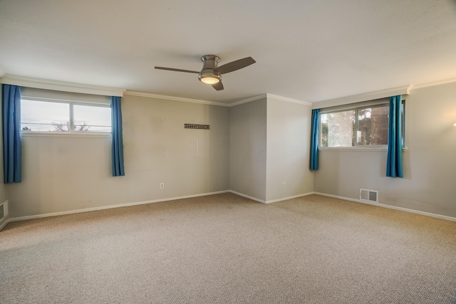 unfurnished room with plenty of natural light, visible vents, and ornamental molding