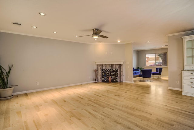 unfurnished living room featuring light wood finished floors, baseboards, a fireplace, and ornamental molding