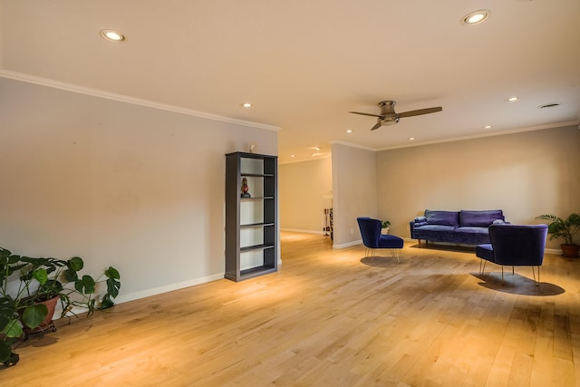 living area with light wood finished floors, baseboards, a ceiling fan, ornamental molding, and recessed lighting