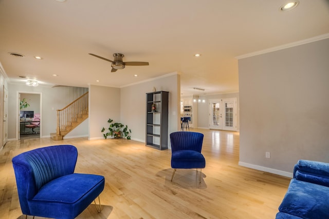 living area with french doors, stairway, light wood-style floors, and crown molding