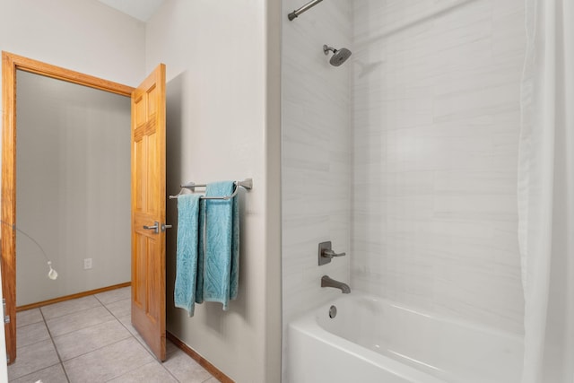 bathroom featuring tile patterned flooring, baseboards, and shower / bathtub combination