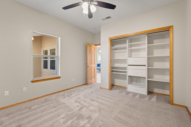 unfurnished bedroom featuring light carpet, baseboards, visible vents, a ceiling fan, and a closet