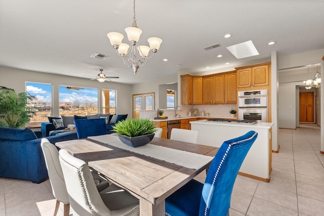 dining space with light tile patterned flooring, ceiling fan with notable chandelier, visible vents, and recessed lighting