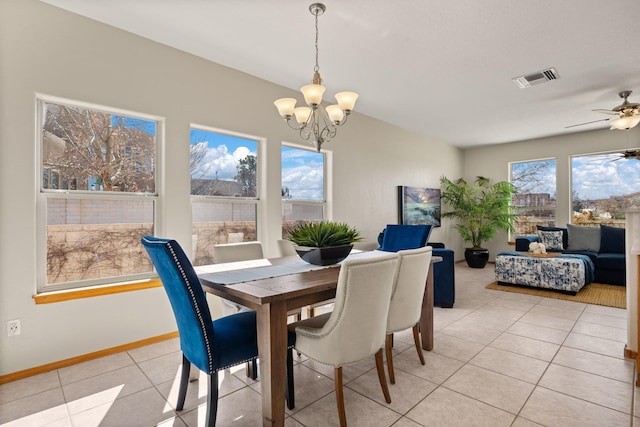 dining area with ceiling fan with notable chandelier, visible vents, baseboards, and light tile patterned flooring