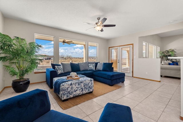 living room featuring ceiling fan, light tile patterned flooring, and baseboards