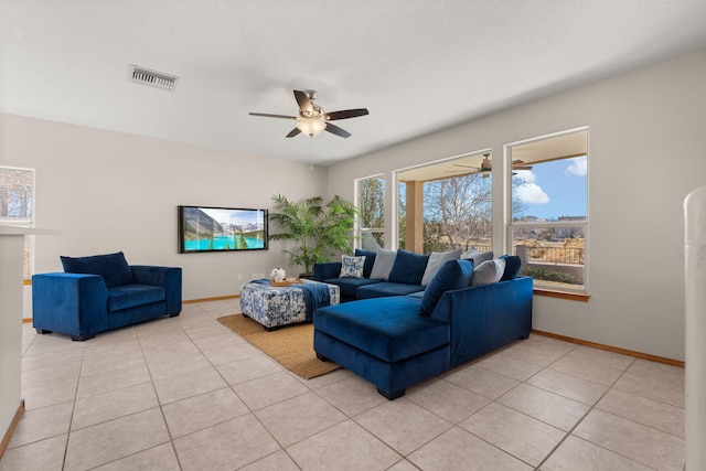 living area featuring light tile patterned floors, baseboards, visible vents, and ceiling fan