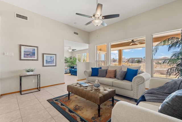 living room with visible vents, baseboards, and light tile patterned flooring