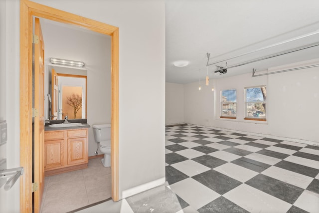 interior space with vanity, toilet, and tile patterned floors