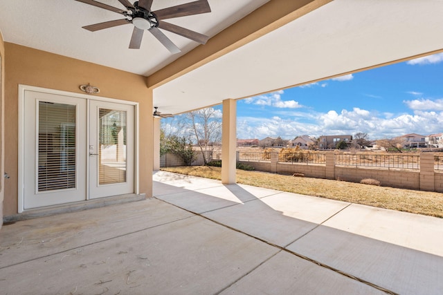 view of patio / terrace featuring french doors, a residential view, a fenced backyard, and a ceiling fan