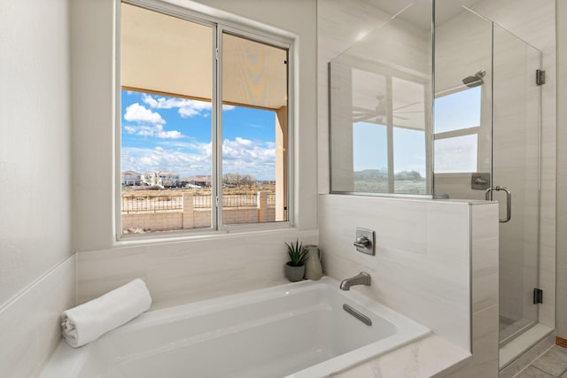 bathroom with a garden tub and a shower stall