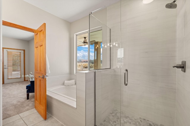 full bathroom with a stall shower, tile patterned flooring, a ceiling fan, and a bath