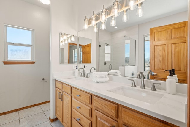 bathroom featuring double vanity, a stall shower, tile patterned flooring, and a sink