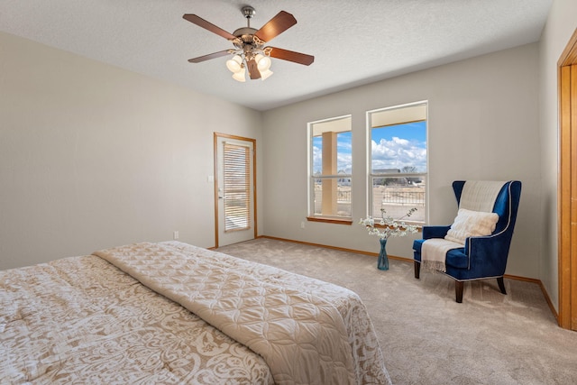 bedroom featuring carpet, baseboards, ceiling fan, and a textured ceiling