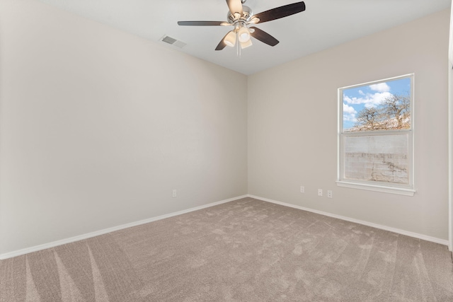 unfurnished room with visible vents, light carpet, and baseboards