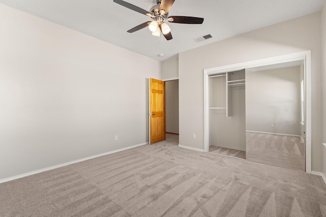 unfurnished bedroom with light carpet, baseboards, visible vents, and a closet