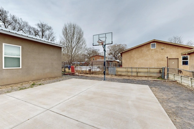 view of sport court featuring fence