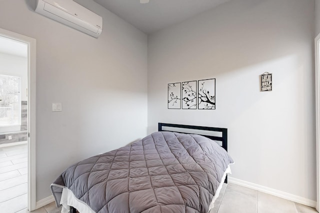 tiled bedroom with a wall unit AC and baseboards