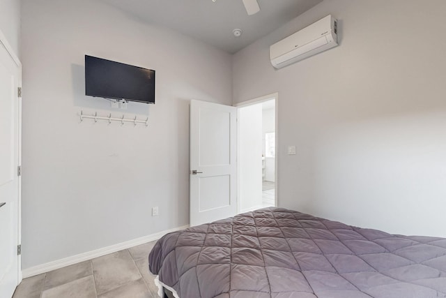 bedroom featuring an AC wall unit, ceiling fan, and baseboards