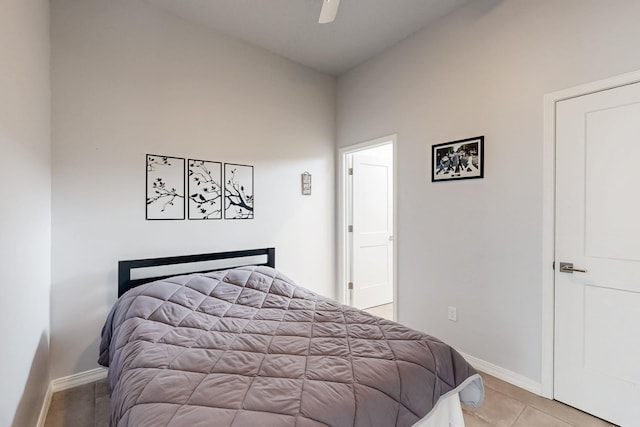 bedroom featuring a ceiling fan, baseboards, and light tile patterned floors