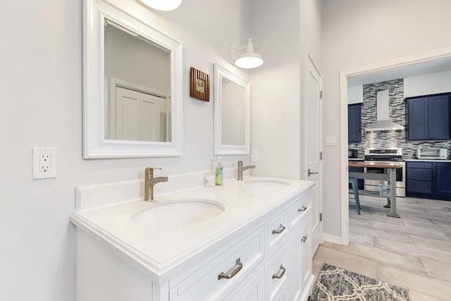 bathroom with double vanity, backsplash, and a sink