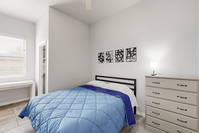 bedroom featuring ceiling fan and baseboards