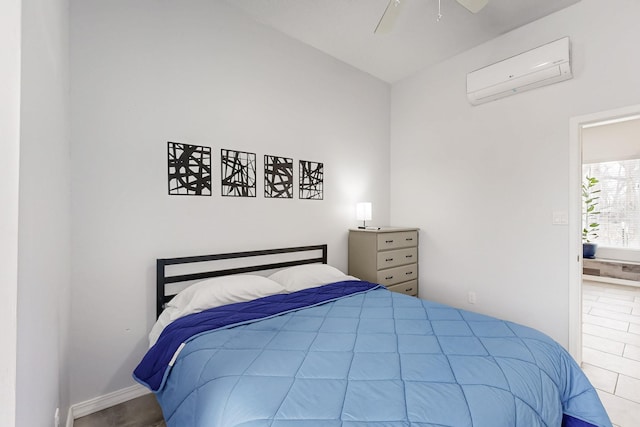 bedroom with ceiling fan and an AC wall unit