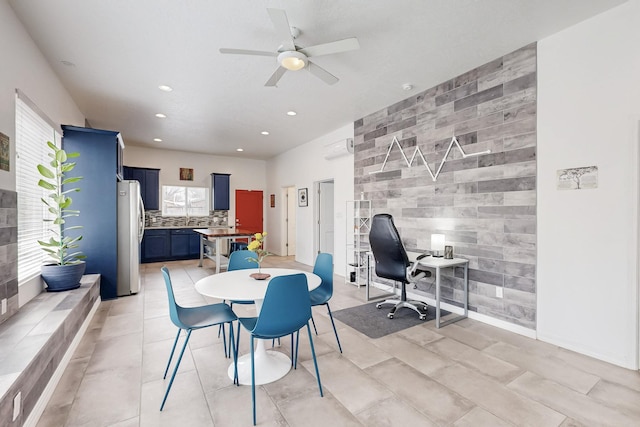 dining area with light tile patterned floors, an accent wall, ceiling fan, and recessed lighting