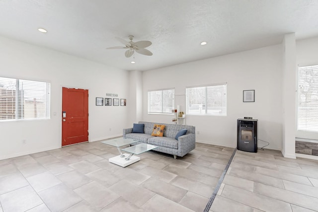 living area featuring ceiling fan, baseboards, a textured ceiling, and recessed lighting