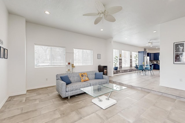 living room with light tile patterned floors, ceiling fan, baseboards, and recessed lighting