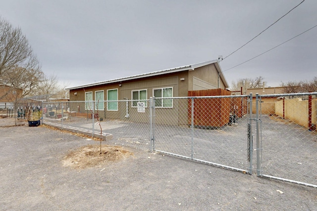 view of front of property with fence private yard, a gate, and stucco siding