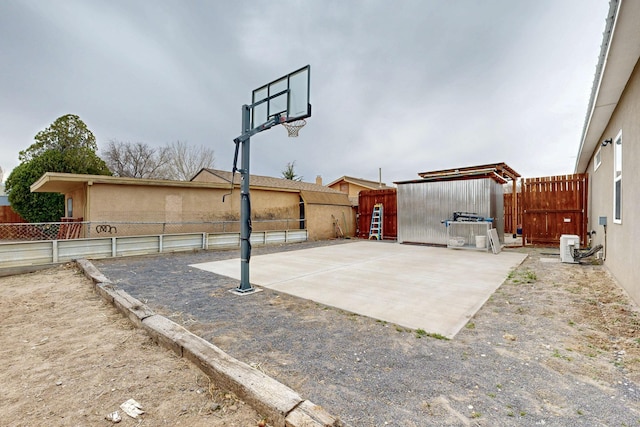 view of sport court featuring fence